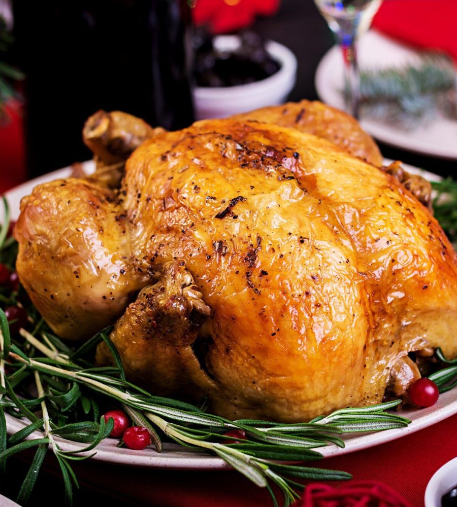 tacchino-al-forno-cena-di-natale-la-tavola-di-natale-e-servita-con-un-tacchino-decorato-con-orpelli-luminosi-e-candele-pollo-fritto-tavolo-cena-di-famiglia_2829-6079
